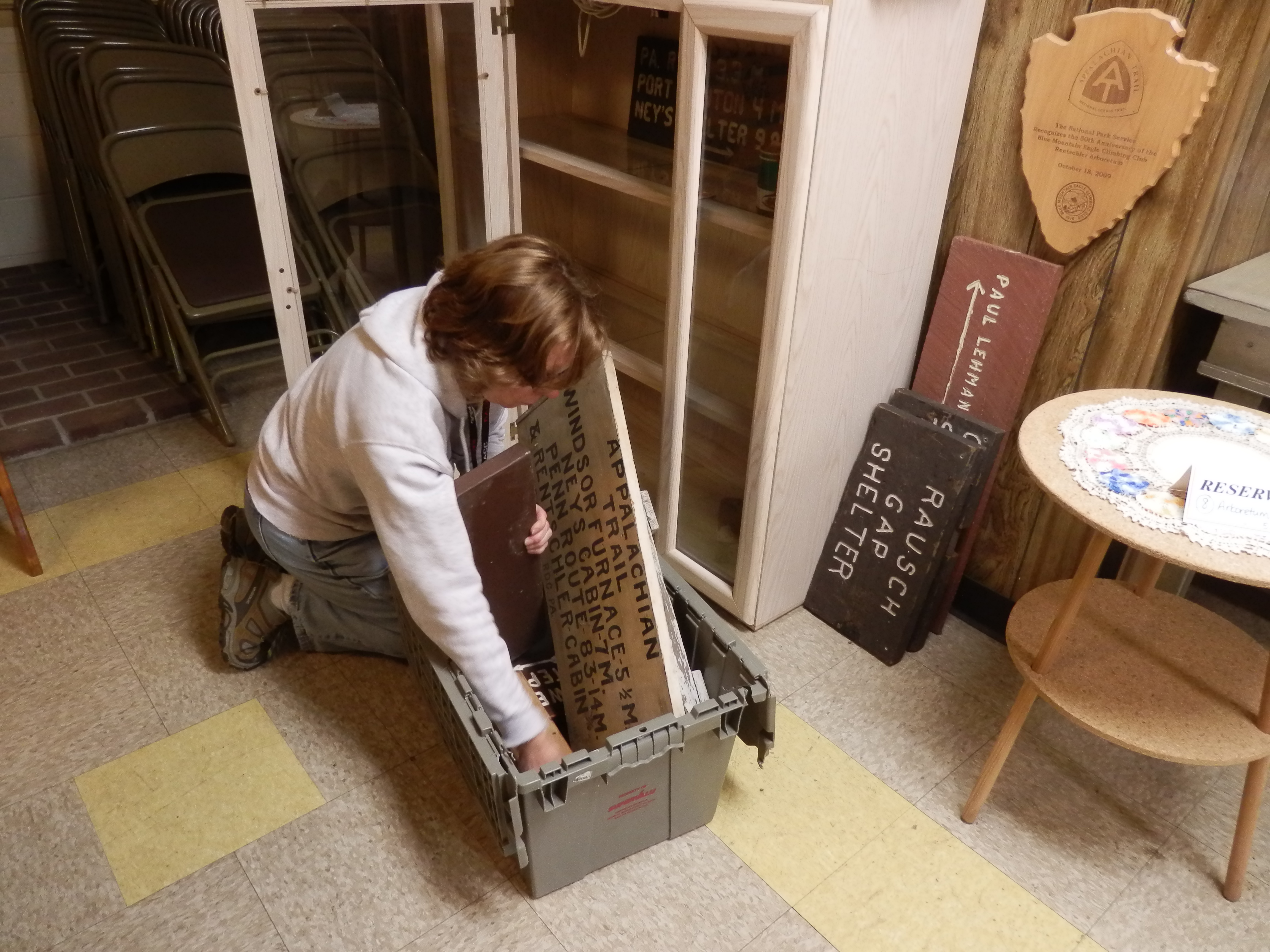 Concerned about the club's archives a member of the Archives' Committee of the Blue Mountain Eagle Climbing Club packs up some of the club's signs to move them to a secure off-site location after a recent burglary.